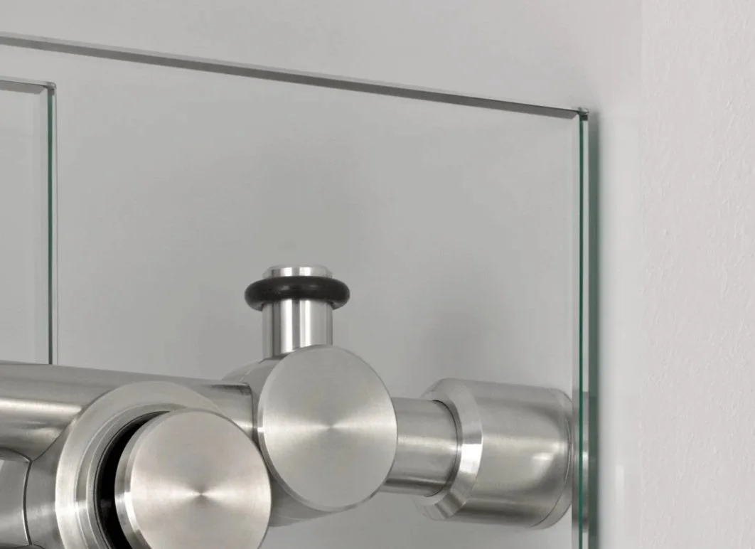 Close-up of a silver telescope mounted on a wall.
