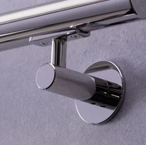 Close-up of a metallic door closer mechanism attached to a door frame.