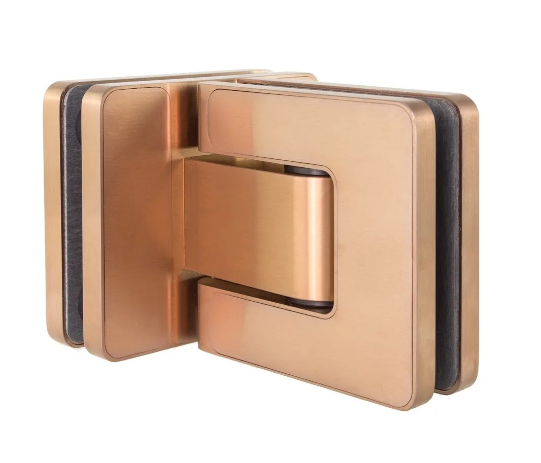 A gold-colored, modern, triple-panel door hinge with black rubber strips.