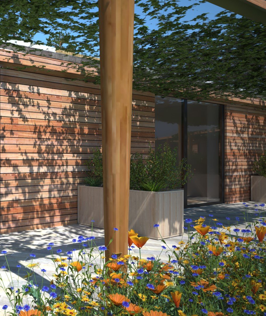 A modern outdoor patio with a wooden post, flower beds with orange and blue flowers, wooden wall, potted plants, and a glass door, shaded by a leafy overhead canopy.