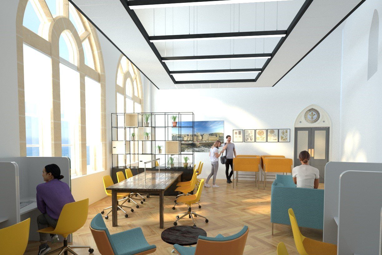 Modern open office space with large arched windows, yellow chairs, and a wooden table. People are working and conversing. Shelving with plants and artwork on the walls.