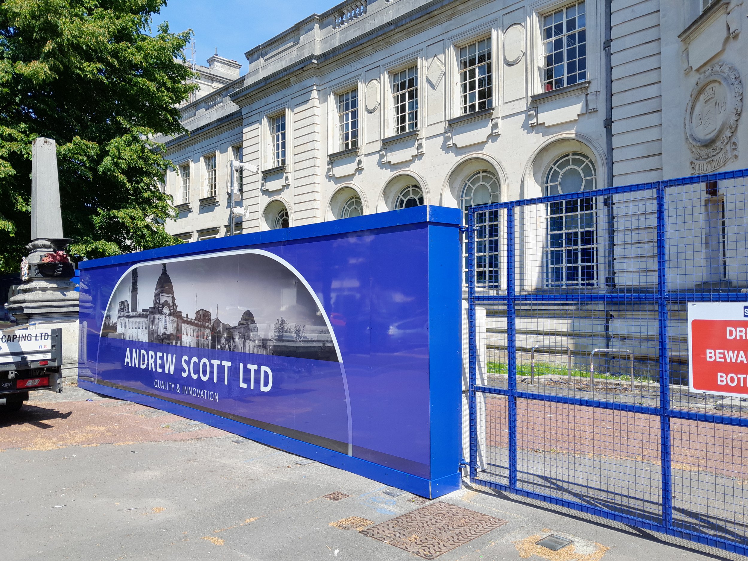 Construction site with blue fence displaying