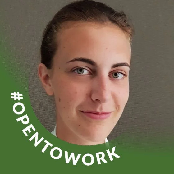 Close-up of a young woman with light skin and brown hair pulled back, smiling slightly, against a plain background with a green semi-circle border and the hashtag '#OPENTOWORK' in white text.