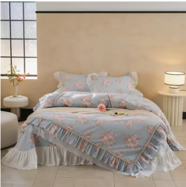 A bed with floral bedding and ruffled trim, flanked by two nightstands with lamps, in a bedroom with a large window.