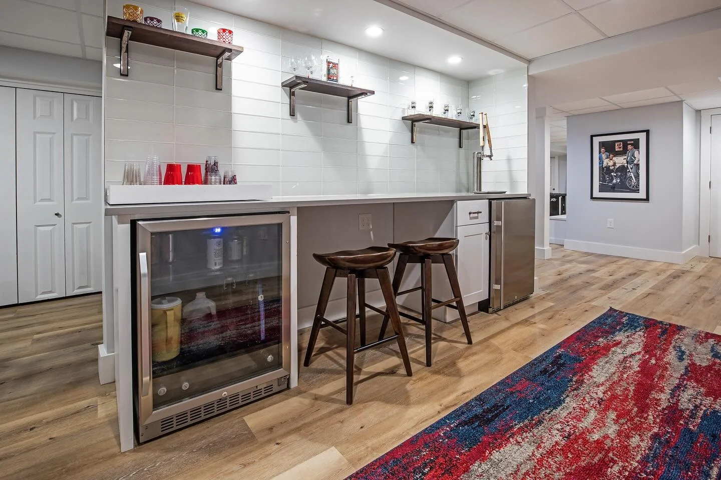 A space made for game nights and good company.
This finished lower level was designed for unwinding in style. Complete with a billiards room, card table, and a custom wet bar featuring a built-in keg tap for Red Sox fans who know how to celebrate eve