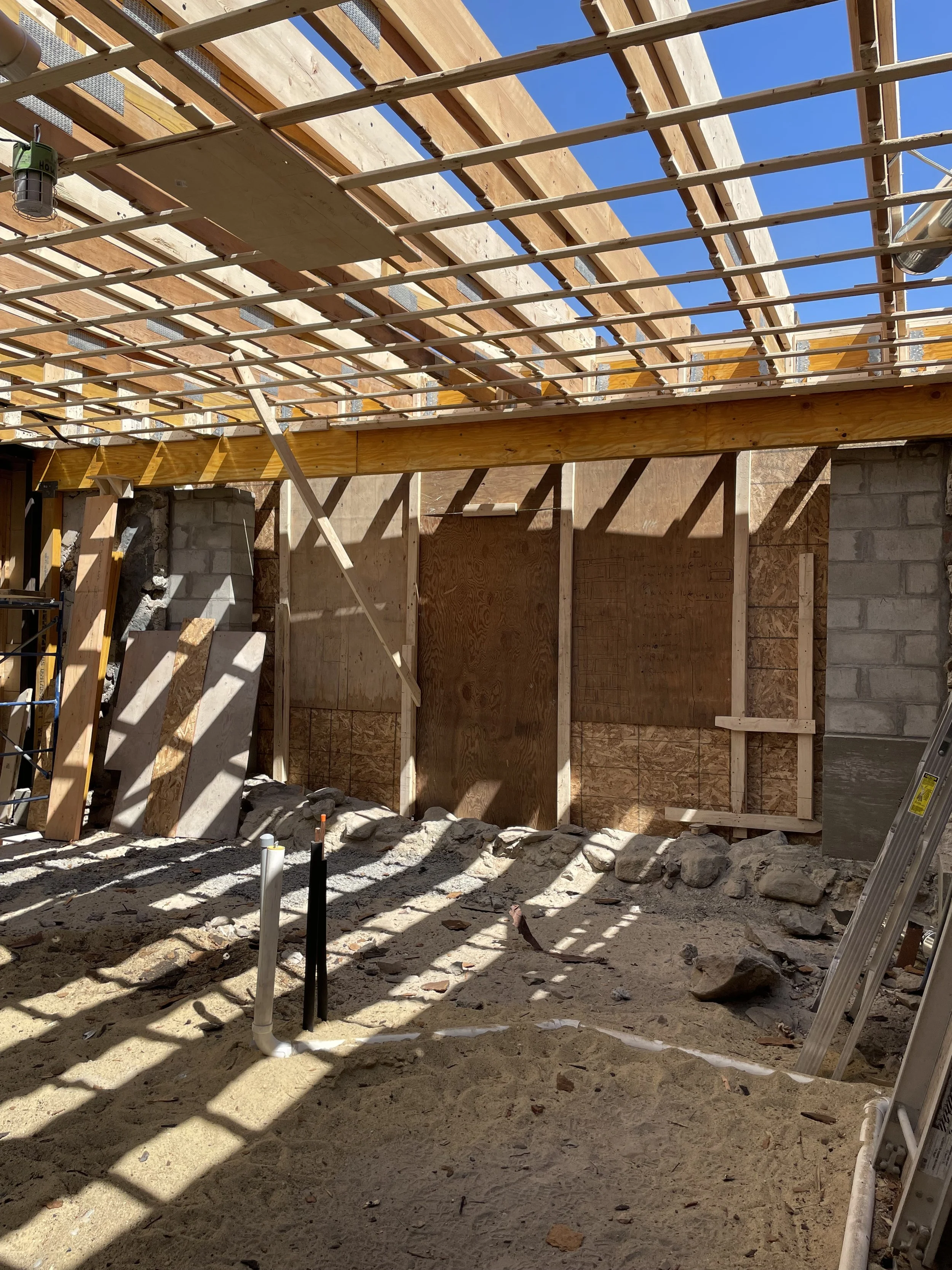 During construction phase of kitchen remodel with new beams, demolished slab floor, new roof framing to support weight of roof and new marvin bi-fold door.