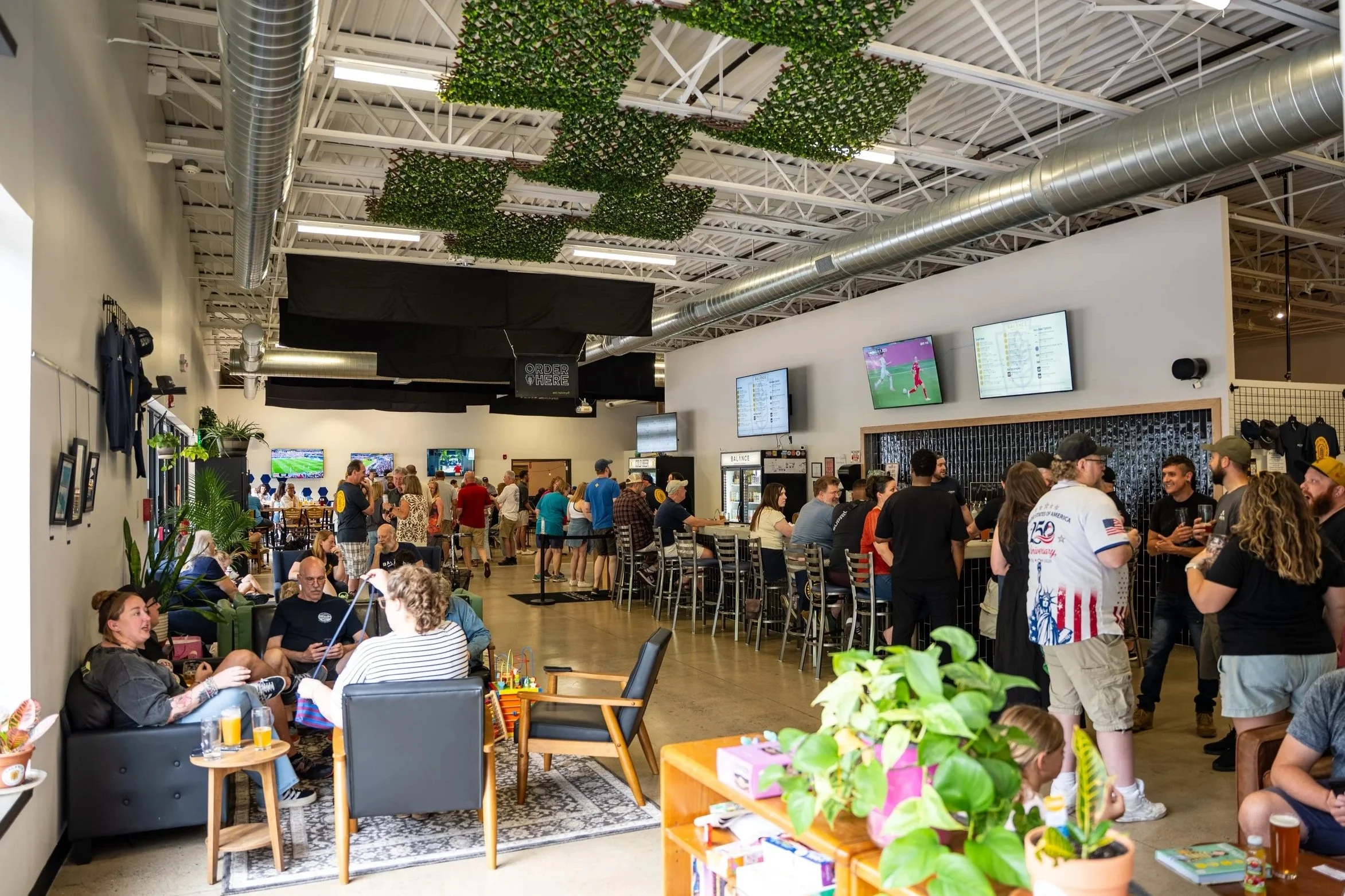 Picture of the taproom with guests  from right to left.