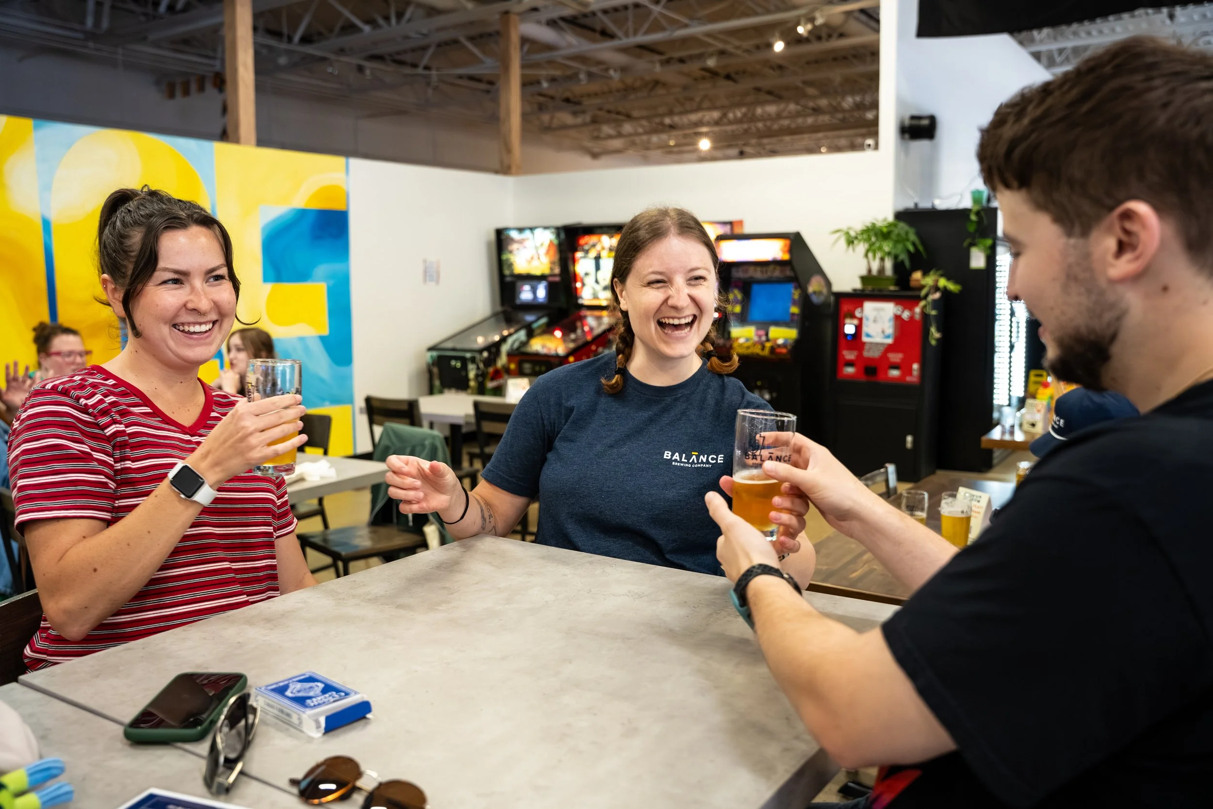 Photo of 3 people smiling at a table.