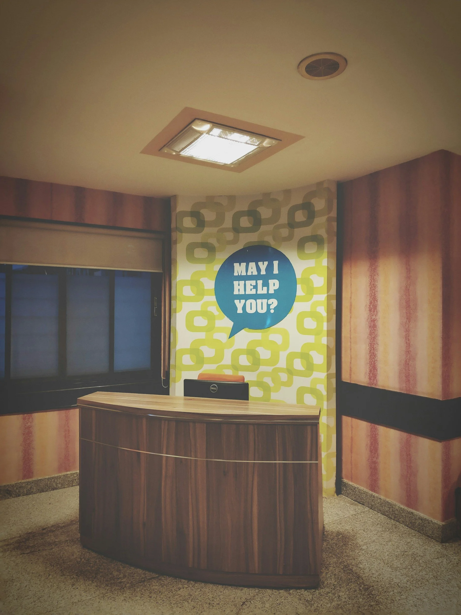 a clean lobby and service desk in the apartment building