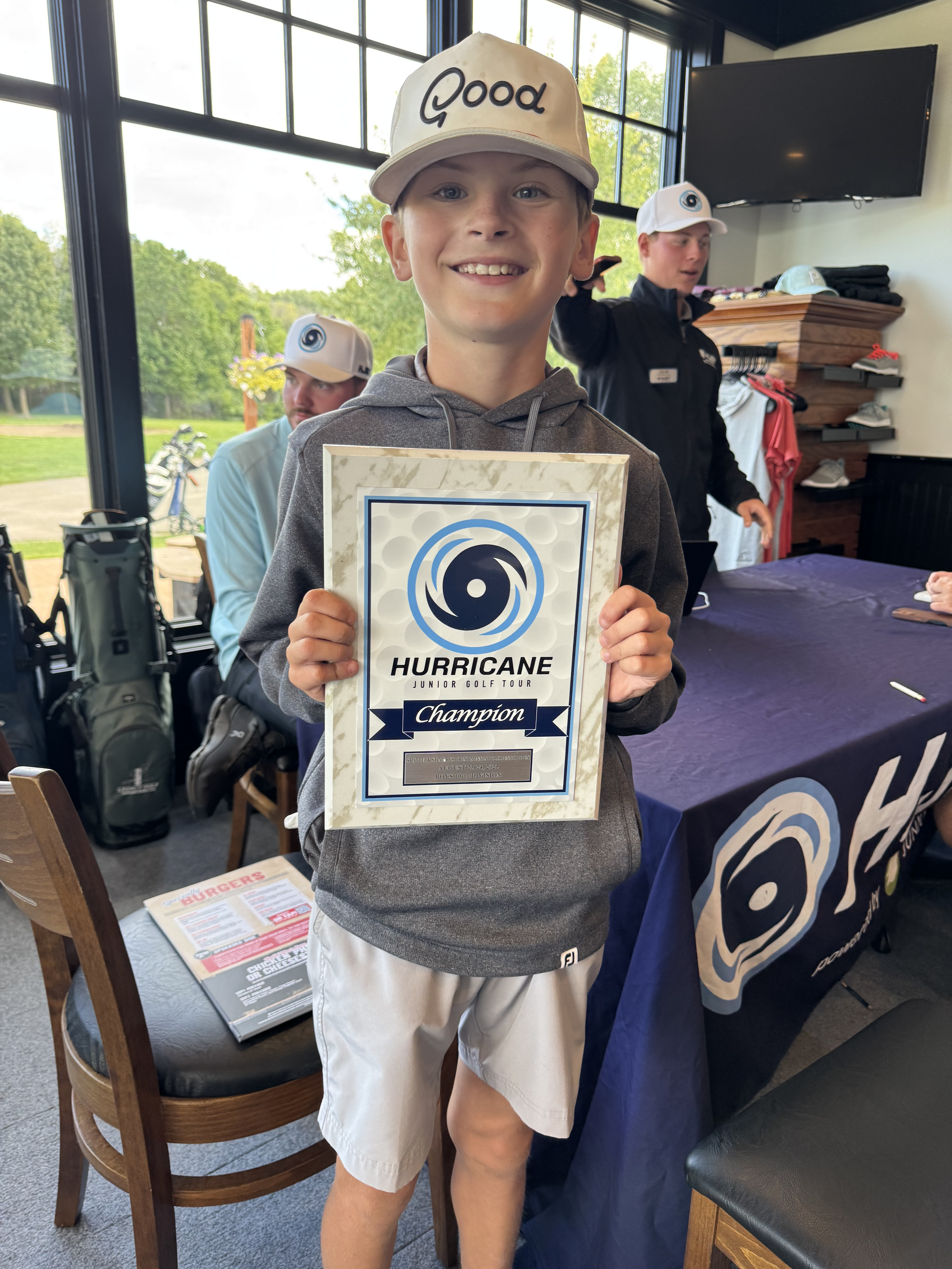Golfer posing with a trophy after a tournament win.