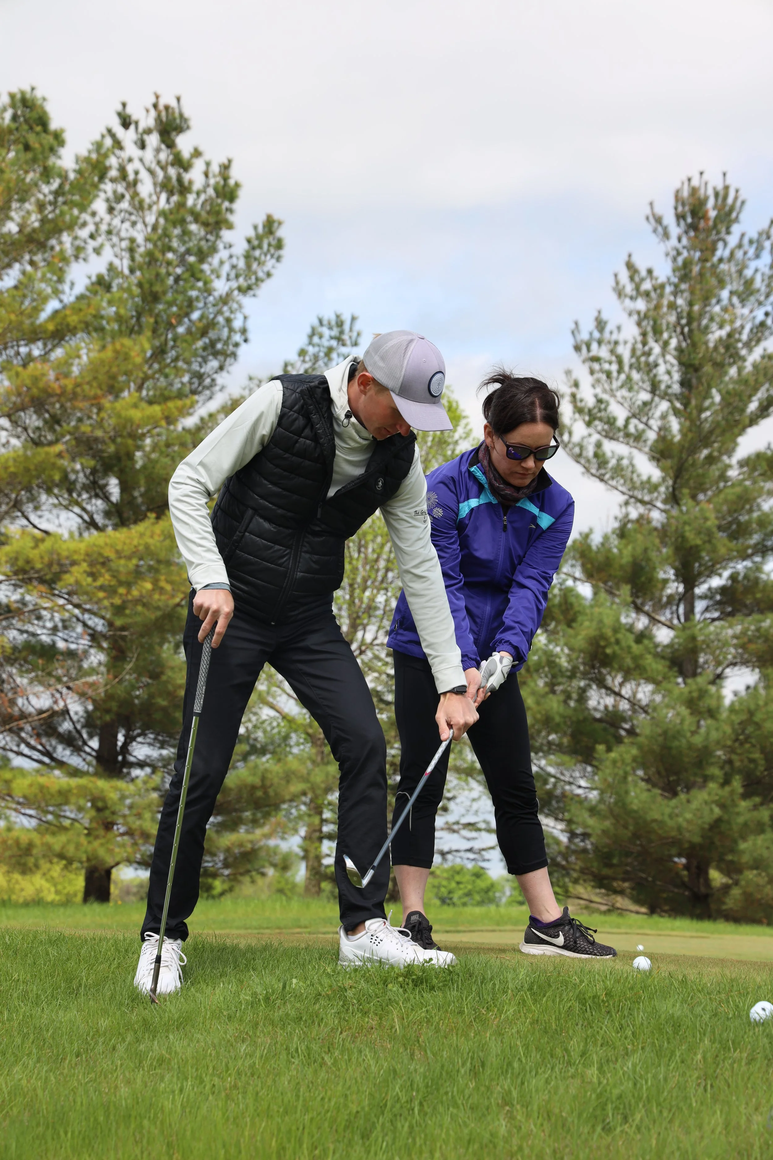 Caleb coaching a student on new swing changes.