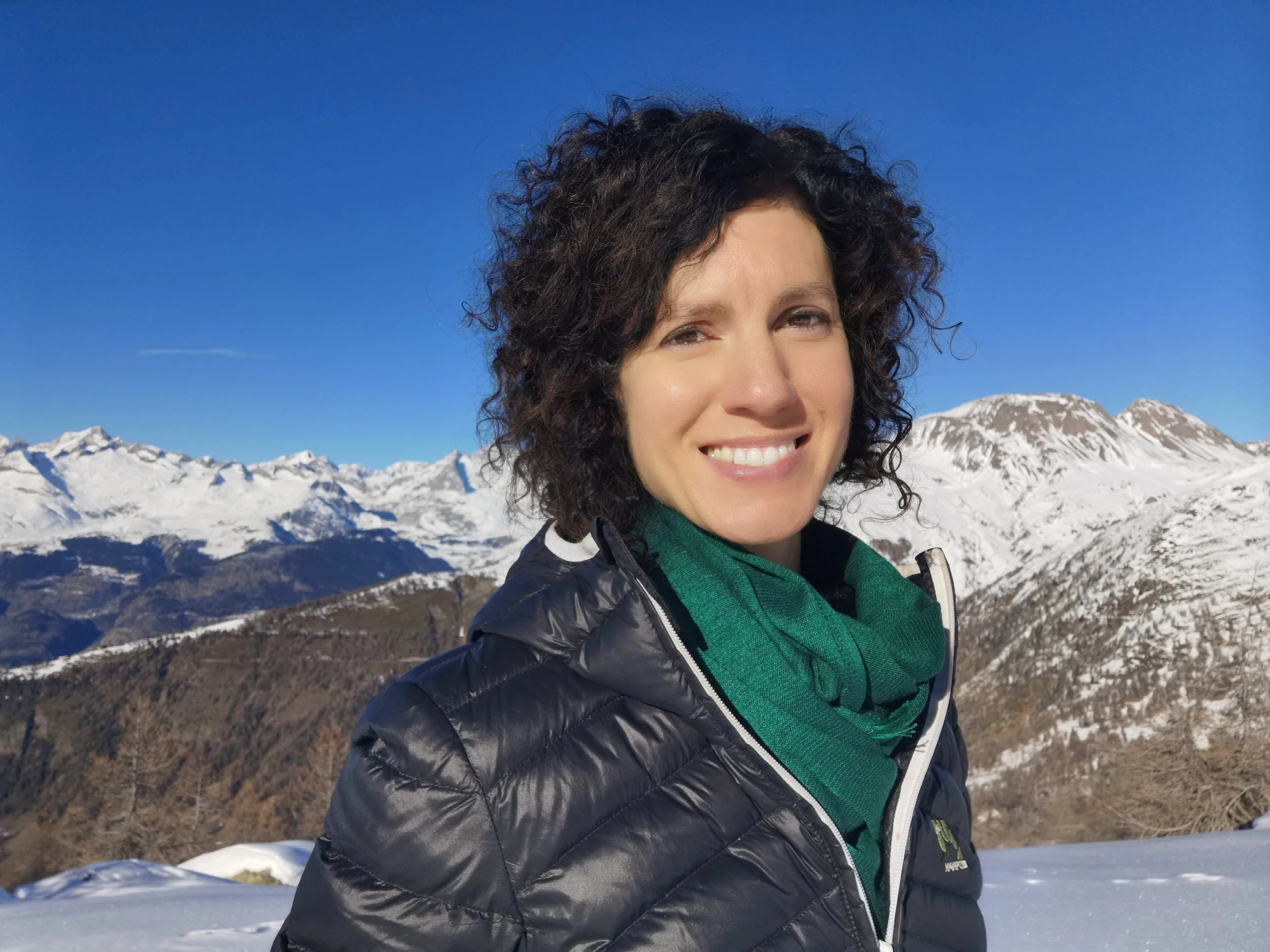 Melanie Shudofsky Leadership Coaching Outdoors standing outdoors in winter on a mountain with clear blue sky.
