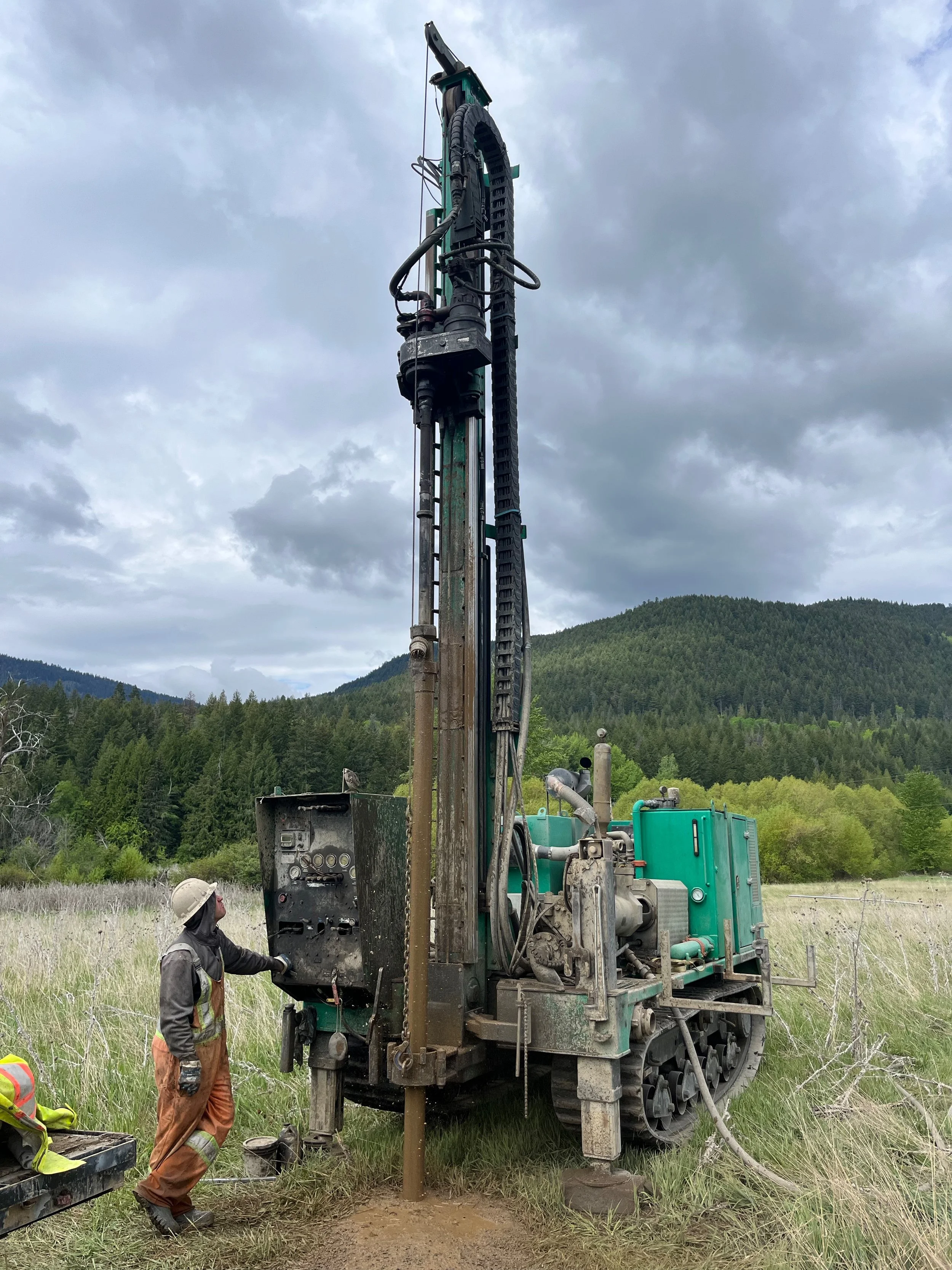Monitoring wells being drilled with a track mounted drill rig for a community wastewater treatments feasibility study.