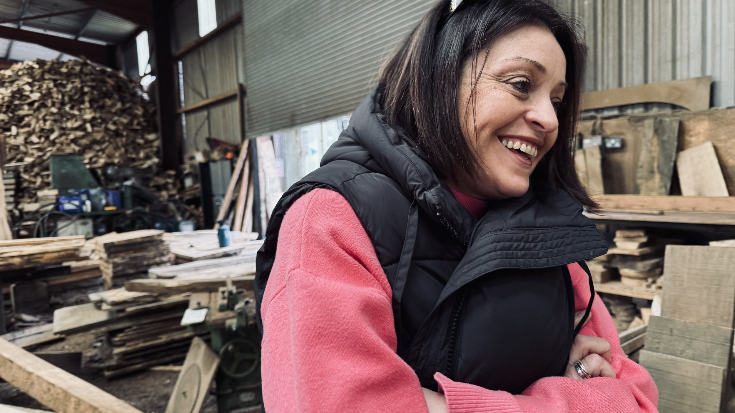 Window view into a cozy bar with "RELAX" written on the glass, dim lighting, and blurred patrons inside.