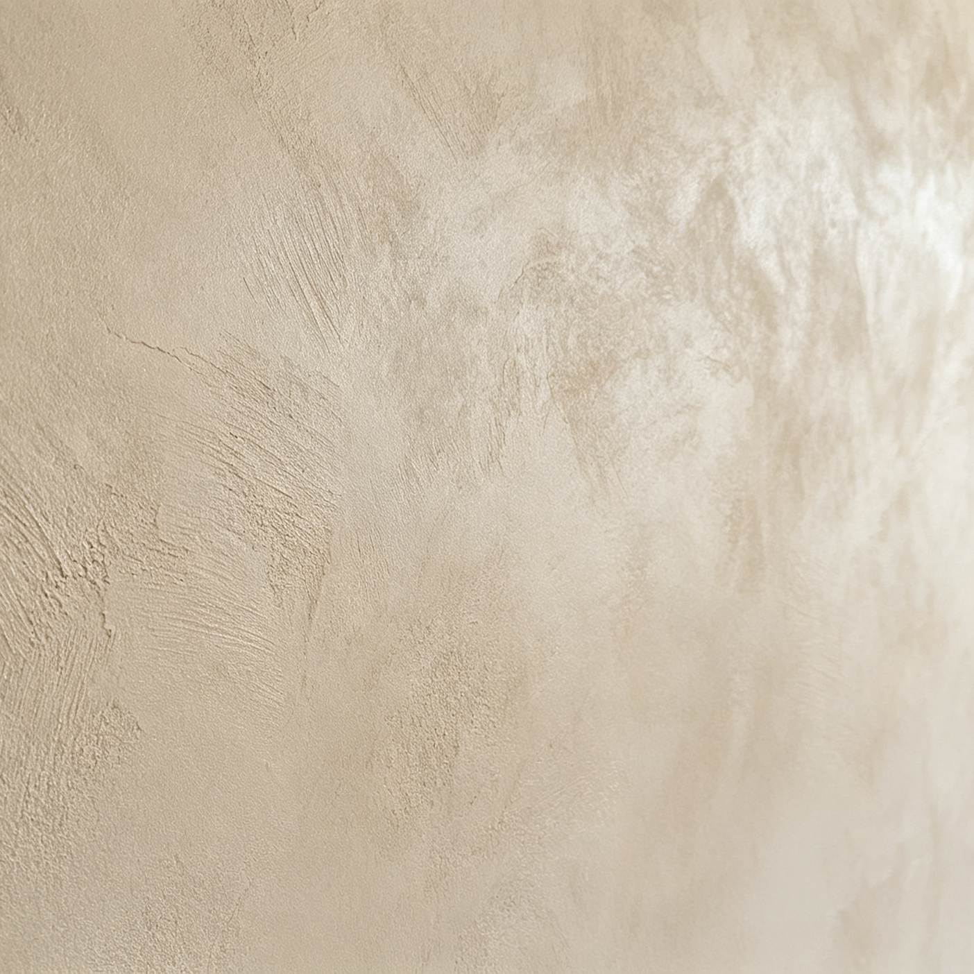 Close-up of a beige textured interior wall with visible stucco finish.