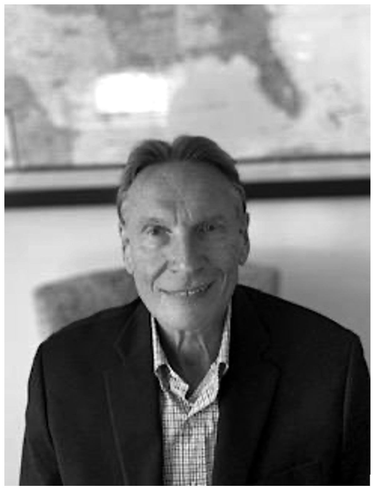 Man in a suit with a framed map background