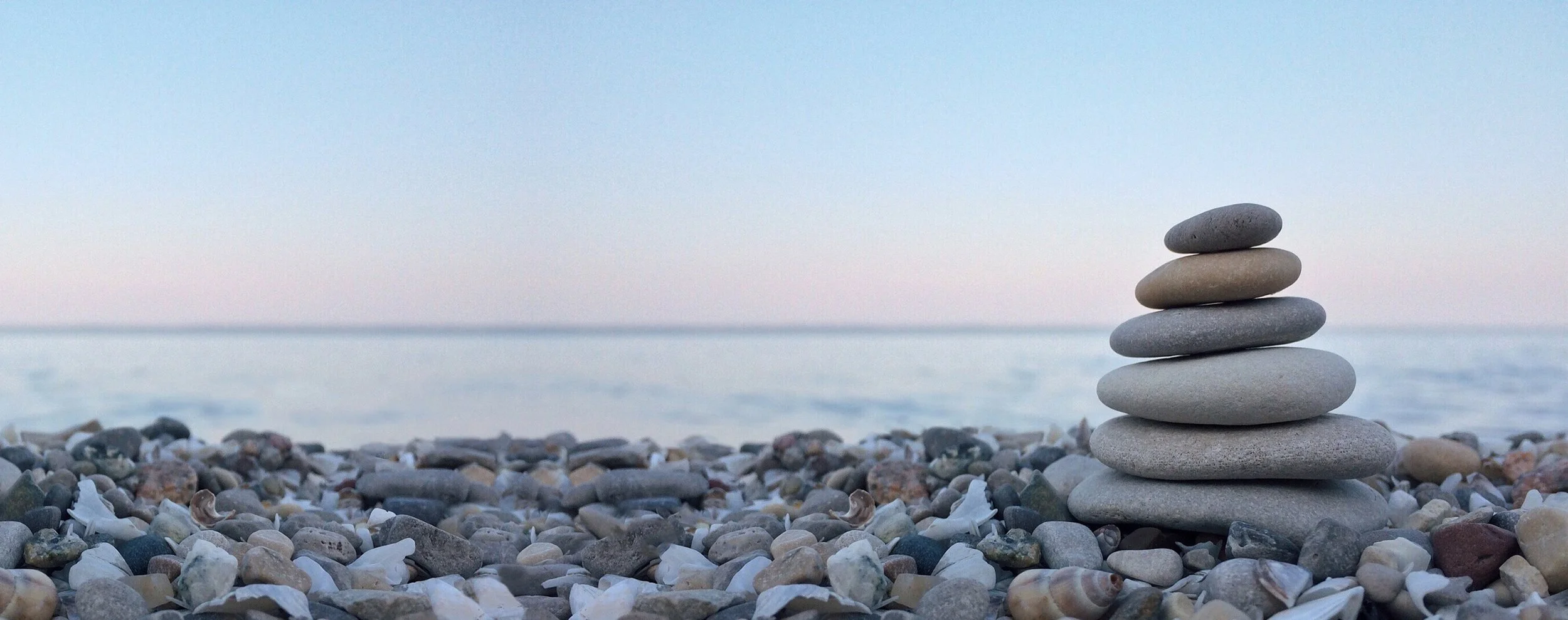 rocky shore with stack of smooth stones