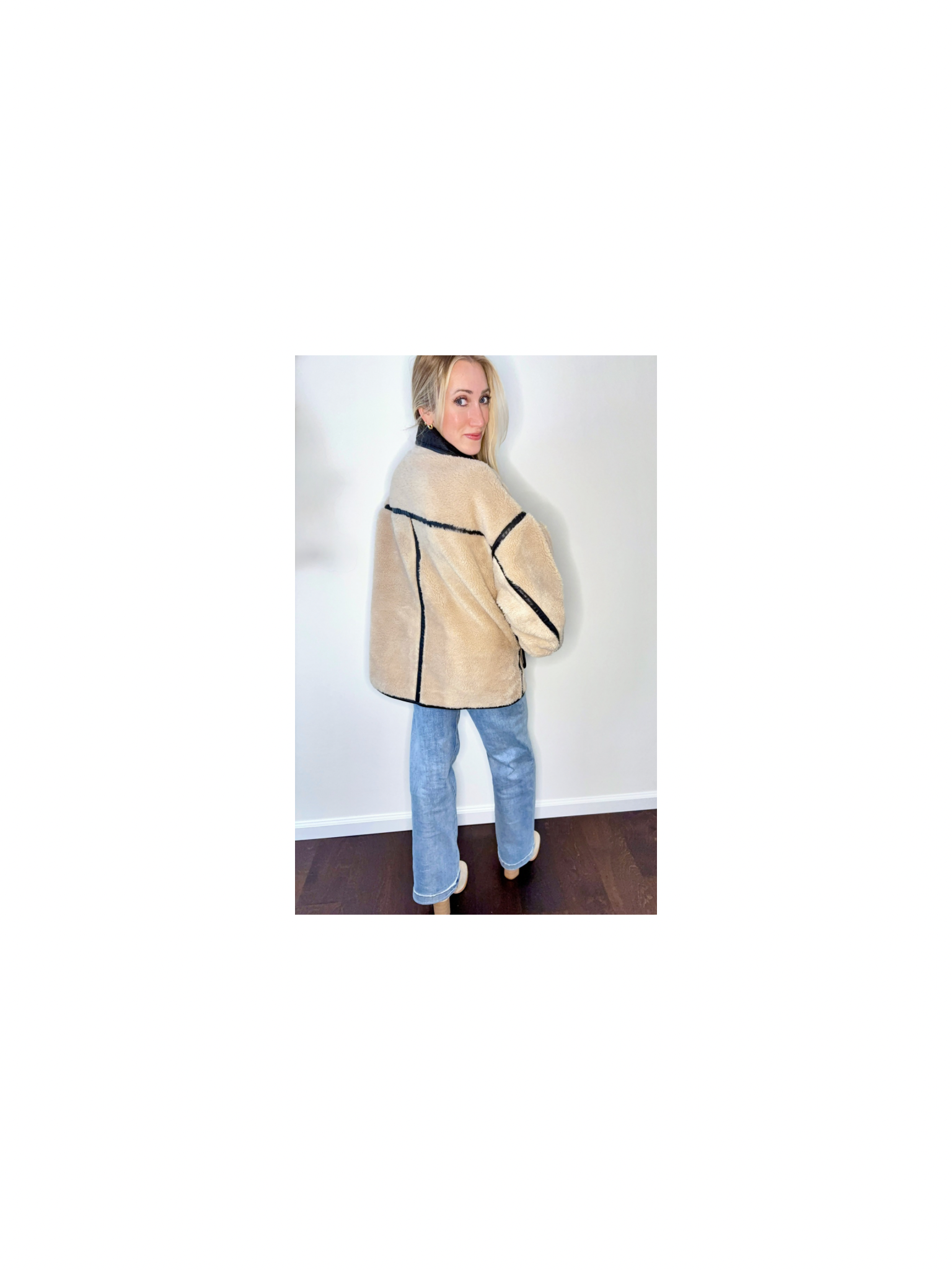 Back view of The Reversible Sherpa showing structured panel details and plush texture.