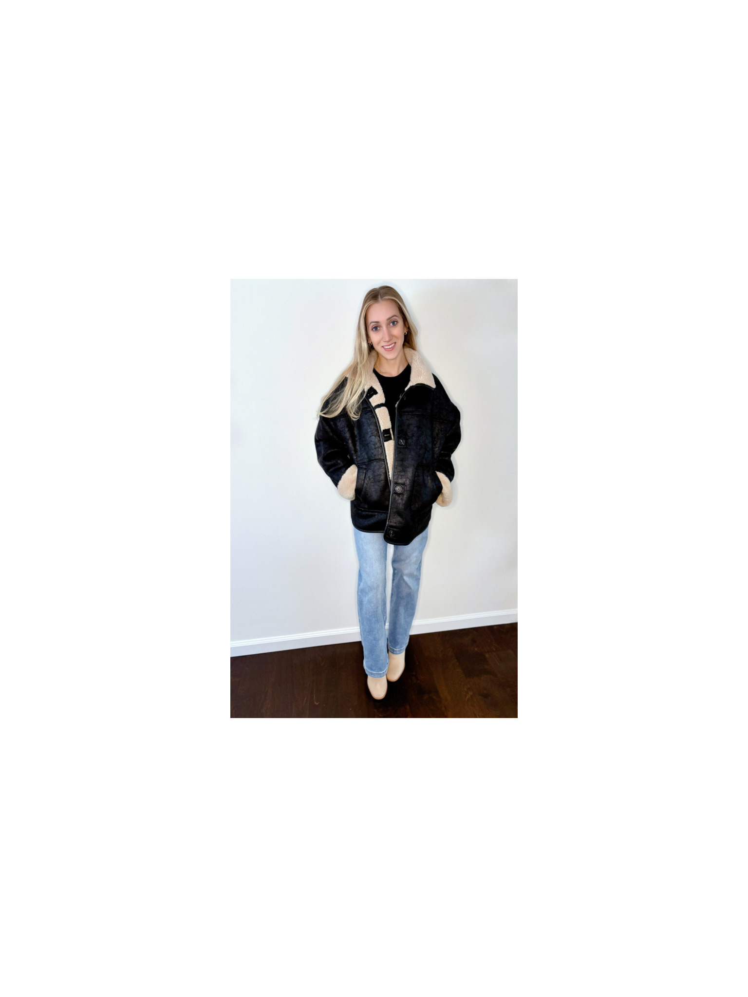 Model wearing The Reversible Sherpa jacket in neutral beige with contrast seams, styled with light denim