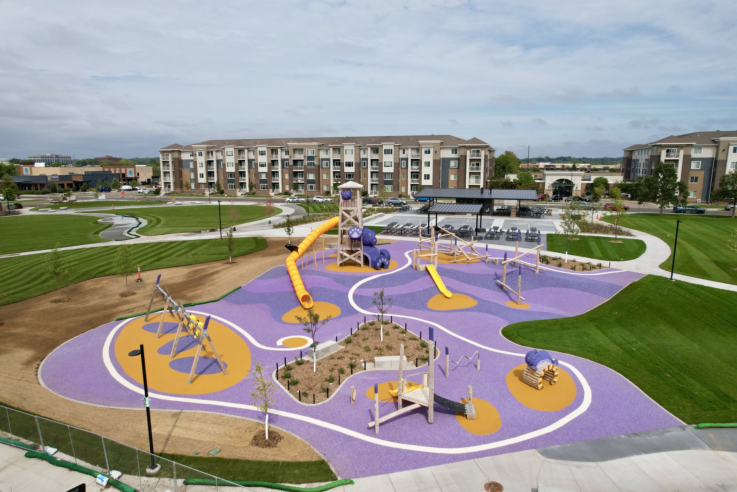 Overhead view of Kelley Park's destination playground with purple and gold poured-in-place surfacing and timber play features