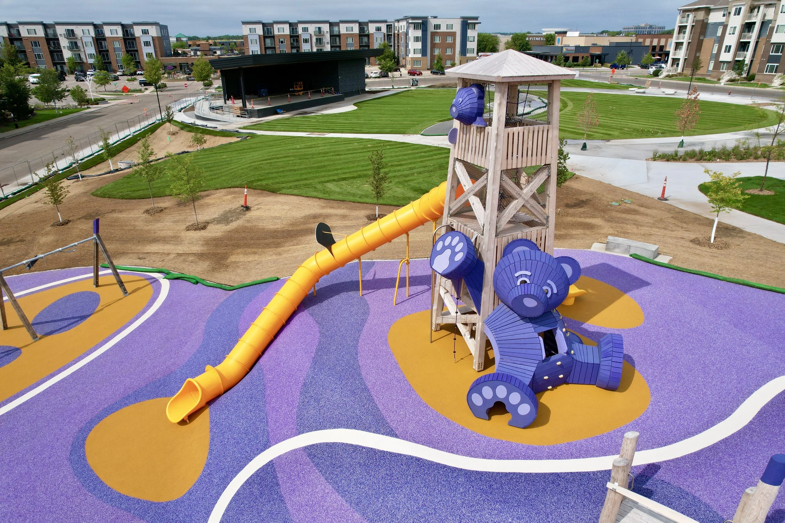 Aerial view of the purple bear timber play tower with yellow tube slide at Kelley Park, Apple Valley, MN
