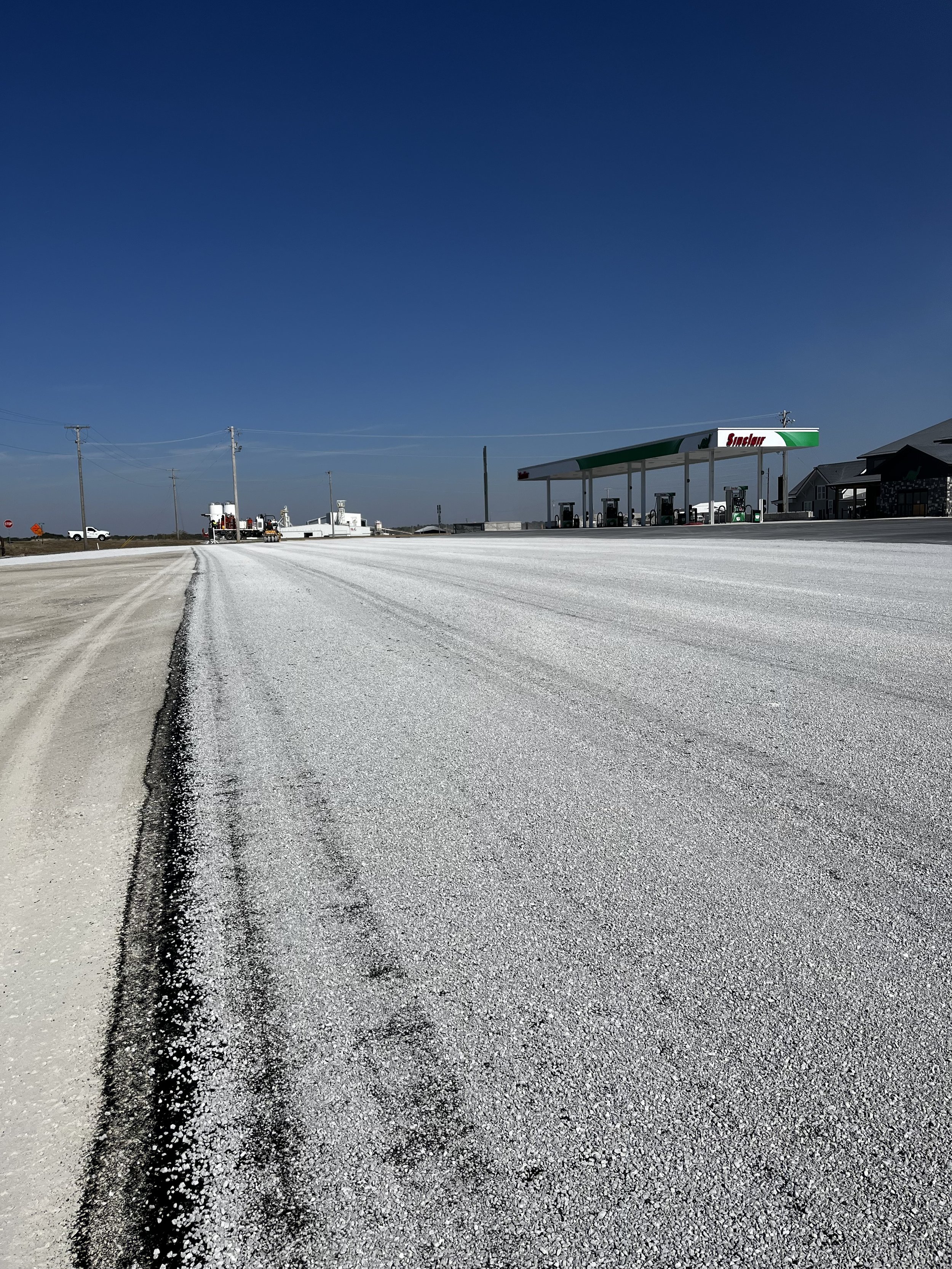 During the process of a full installation of a chip and seal and asphalt parking lot for a sinclair station