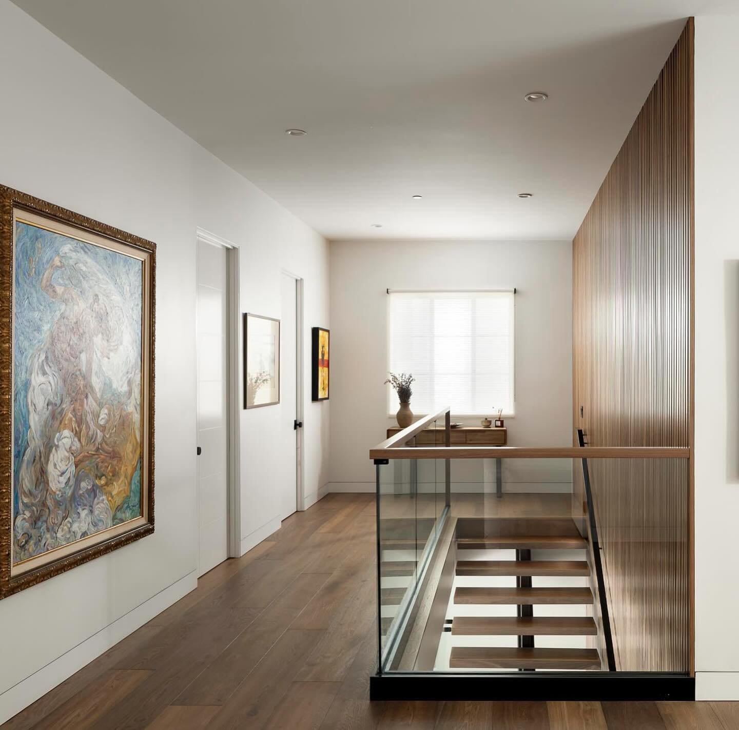 Upstairs -&gt; downstairs one of our favorite features at our Highland modern house  was our custom walnut slat wall.  The wood pieces went from the ground floor to the ceiling creating a showcase moment.