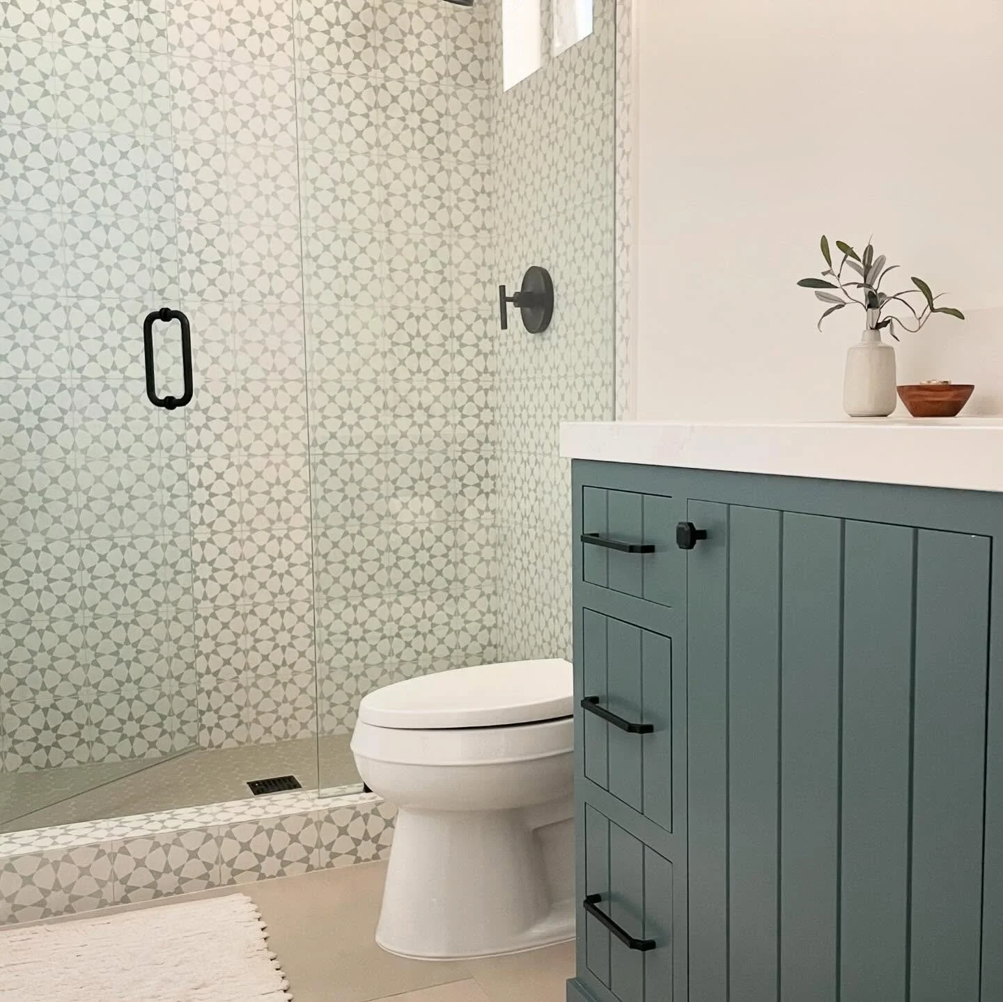 We love a pattern statement tile with a bold color to match.  With a custom in-set cabinet doors and a toe-kick detail the vanity could just steal the show.