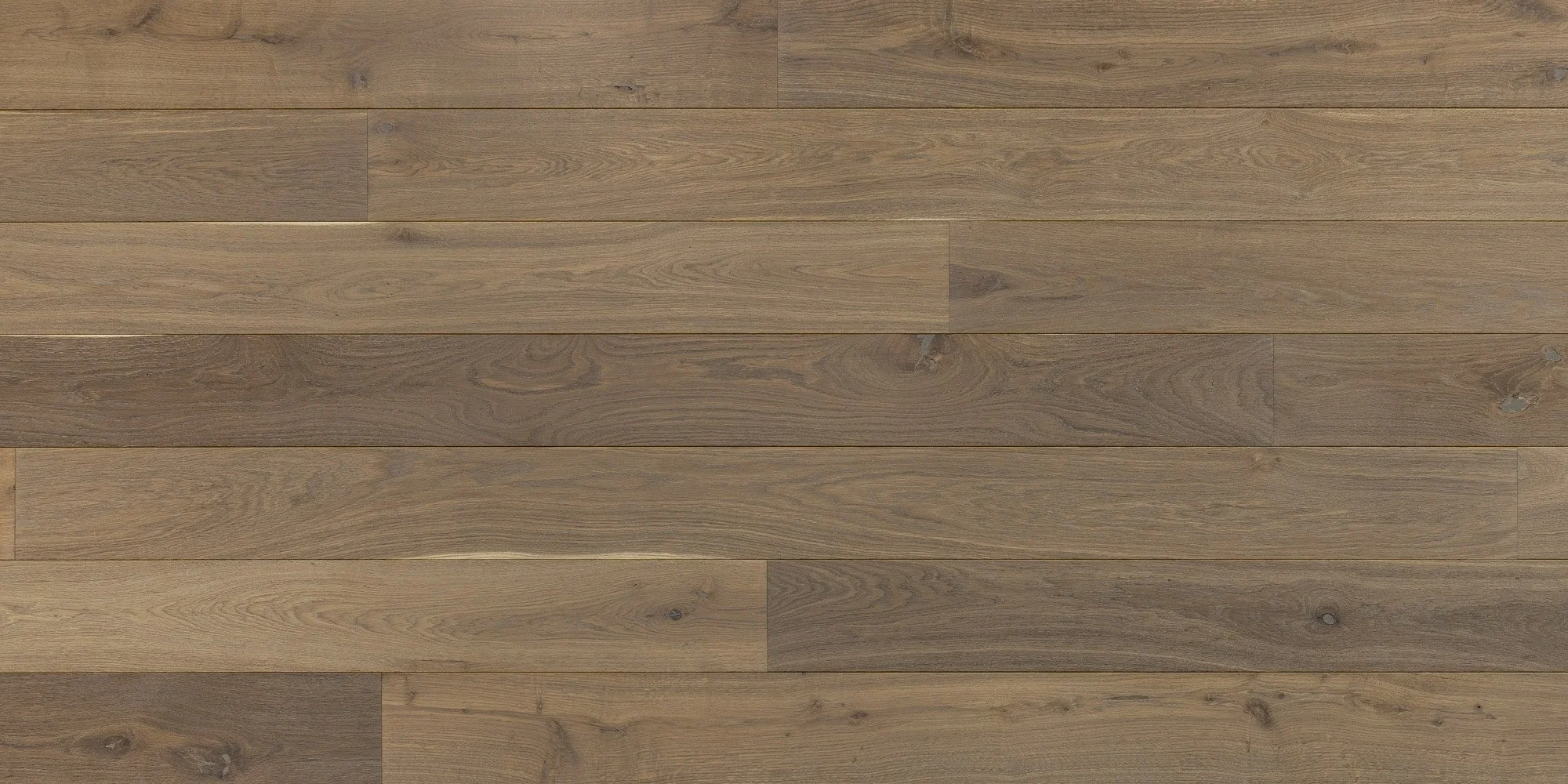 Houten vloer met lange planken in variaties van licht tot donkerbruin.