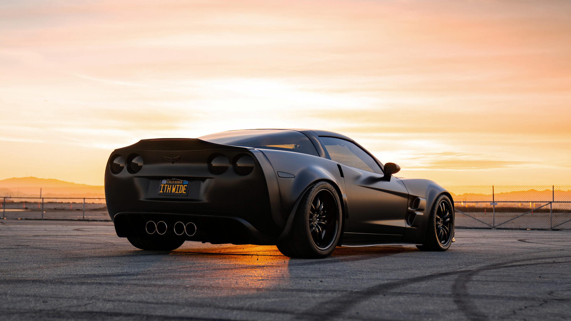 Supervettes ZR6X custom C6 Corvette widebody conversion in matte black, photographed at sunset.