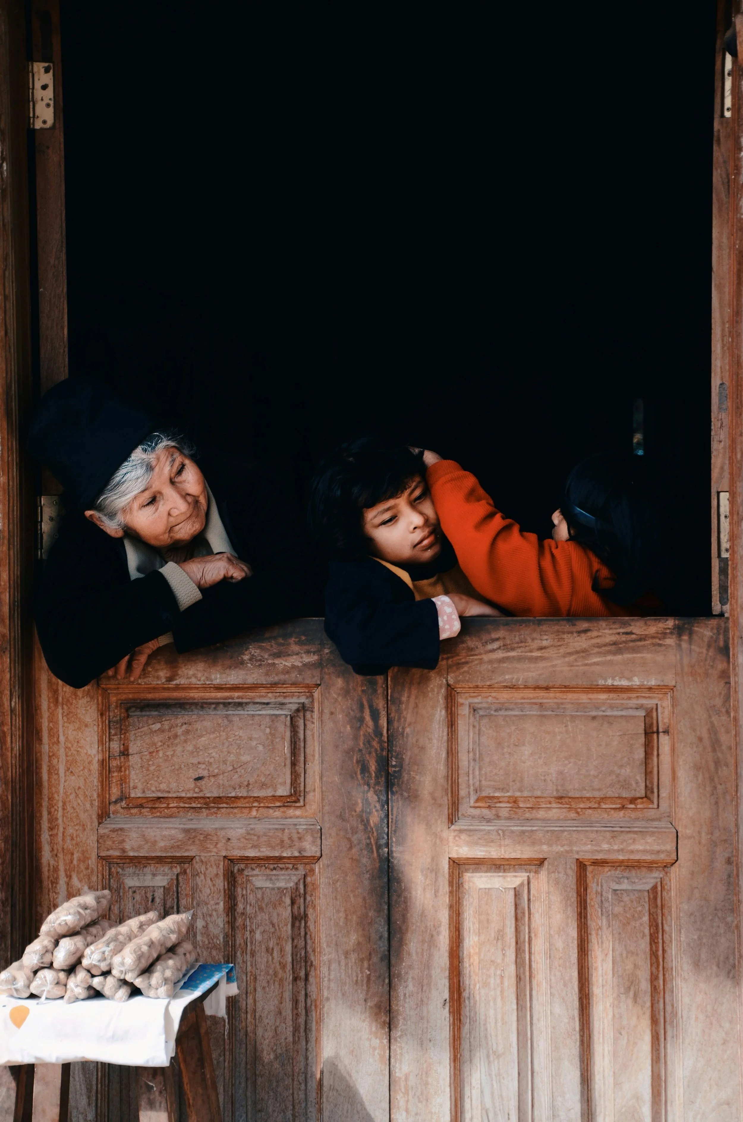 Woman girl and younger sister inside a room