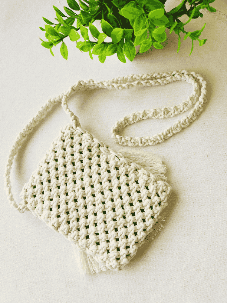 Back view of woven macramé phone bag in off-white cotton – boho textured pattern