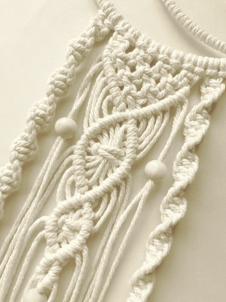 Close-up of handmade macramé crescent moon wall hanging with intricate cotton knots and wooden beads – Islamic boho decor by Samra Knots