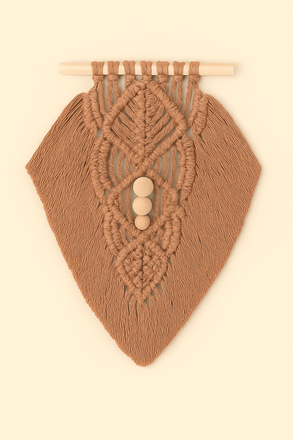Earthy-toned macramé wall hanging in light brown yarn with detailed knotwork and wooden beads, flat lay style on beige background.