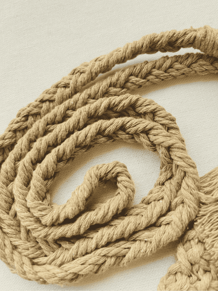 Close-up of the light brown cotton macramé strap showing intricate braided design and soft fibre texture.