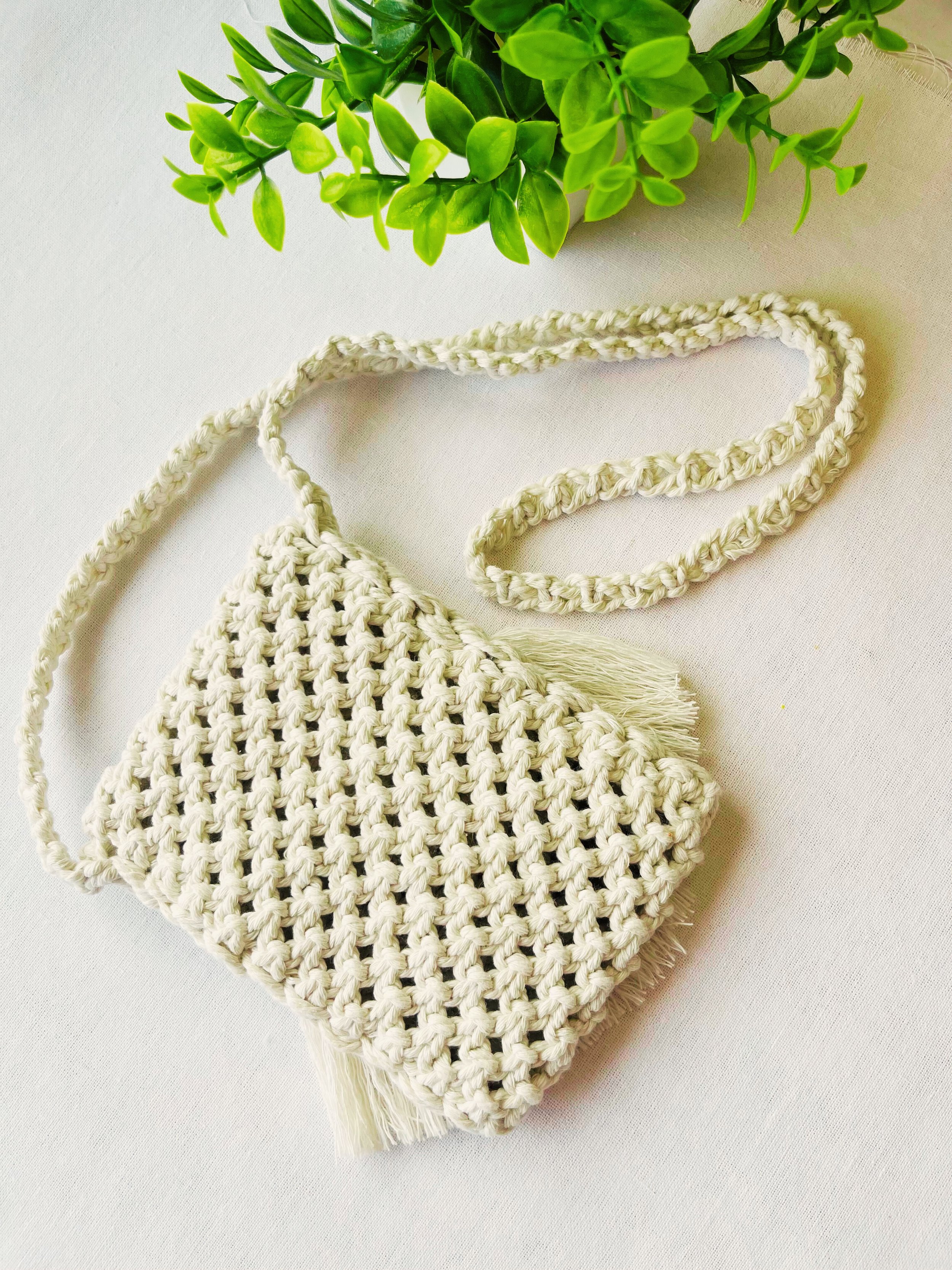 Back view of woven macramé phone bag in off-white cotton – boho textured pattern