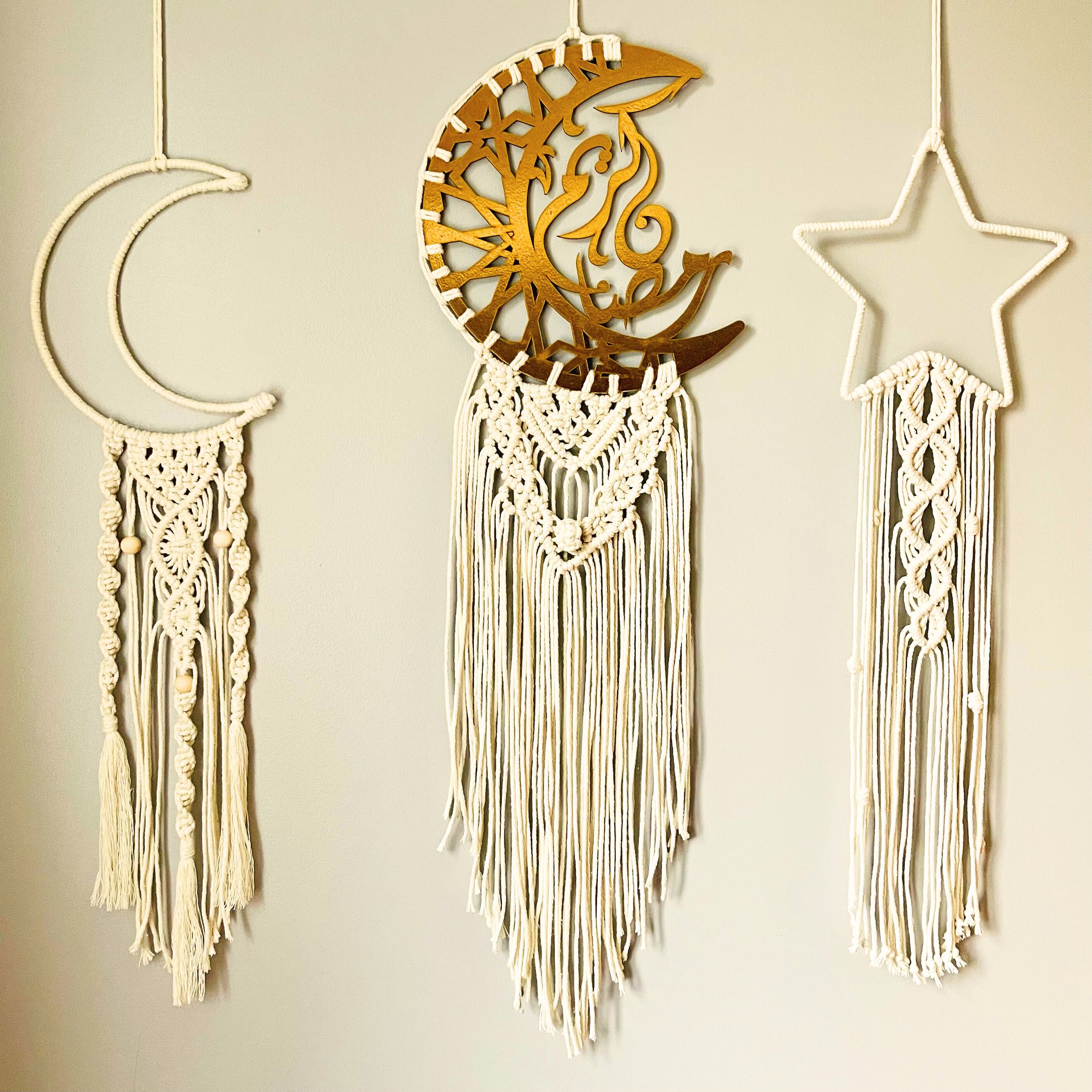 Handmade Islamic macramé wall hanging set featuring moon, Arabic calligraphy crescent, and star designs in off-white cotton cord with gold accents.