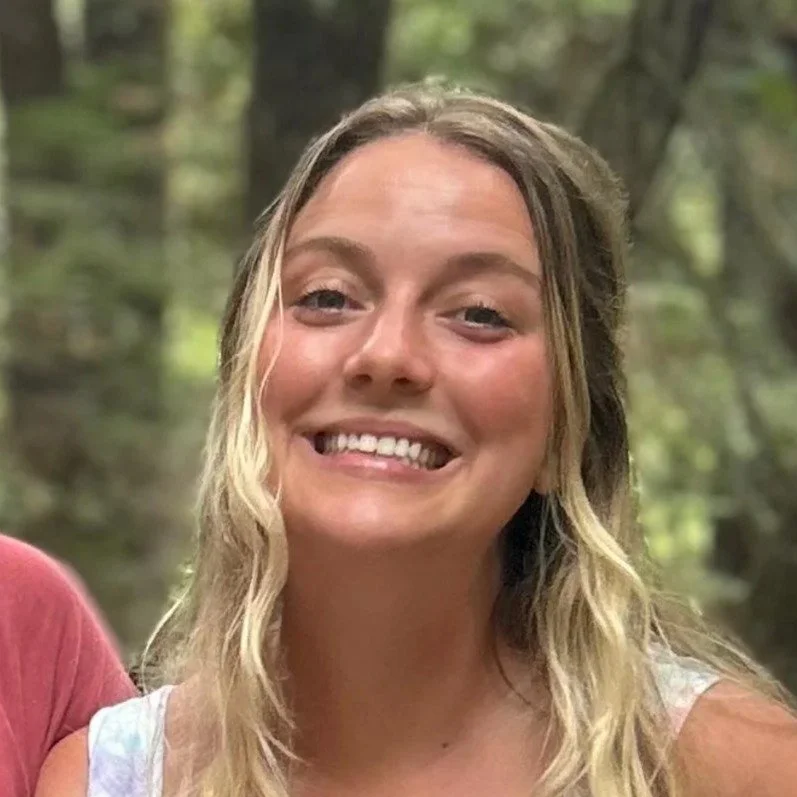 Lindsey Nowak, Family Adventure Squad team member, smiling in a forest