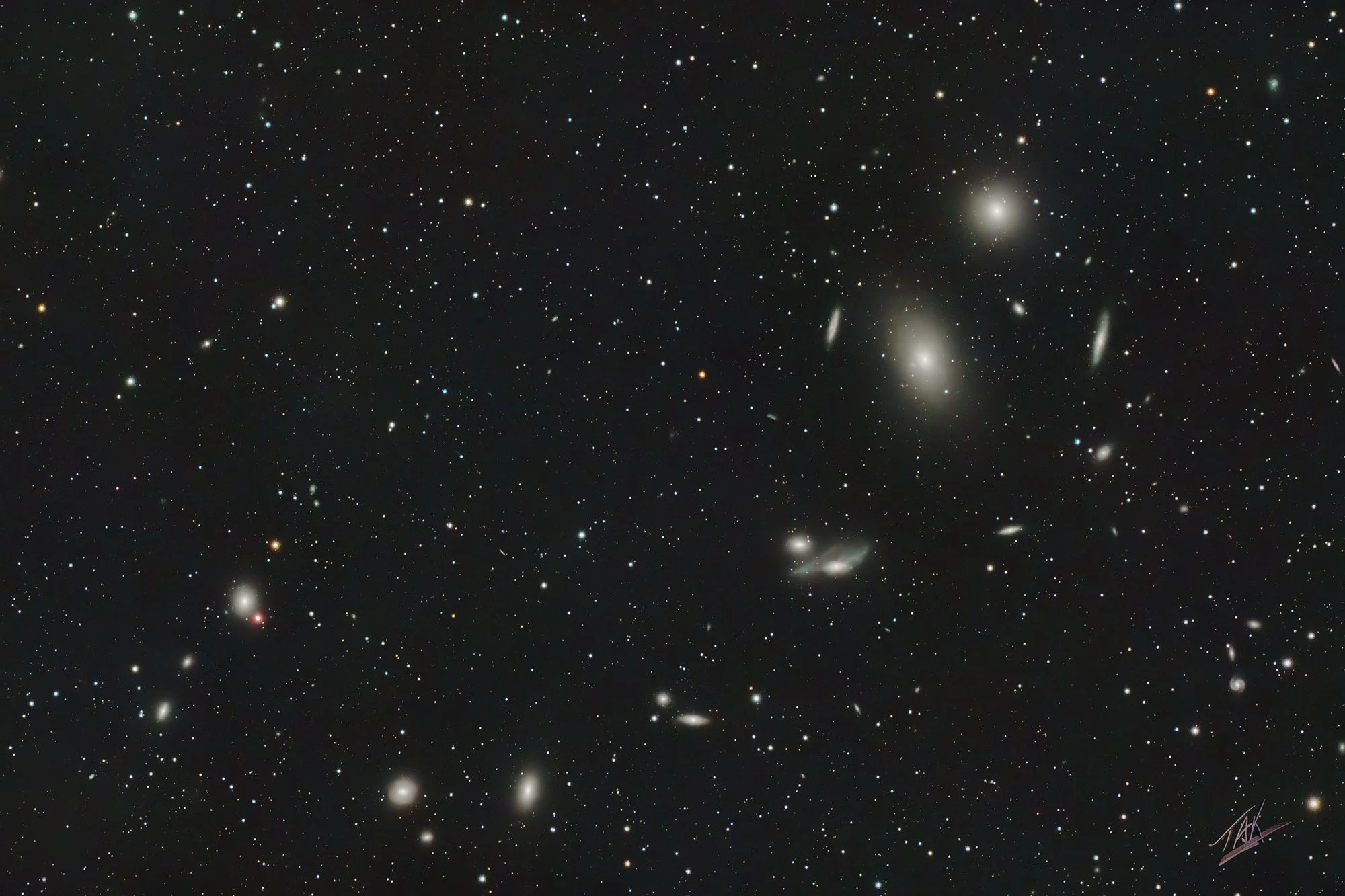 This amazing scene is called Markarian's Chain.  It is a scattering of galaxies that is part of what is called the Virgo Cluster.  How many galaxies can you count?  This image is compiled from 41 five-minute long exposures.  