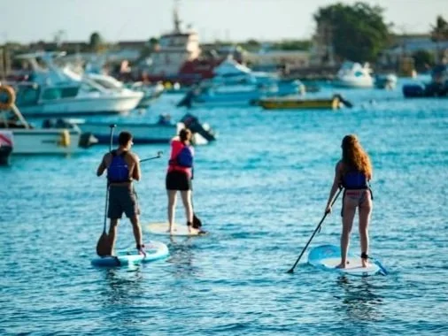 3 people on stand up paddle in Darwin Bay San Cristobal Galapagos