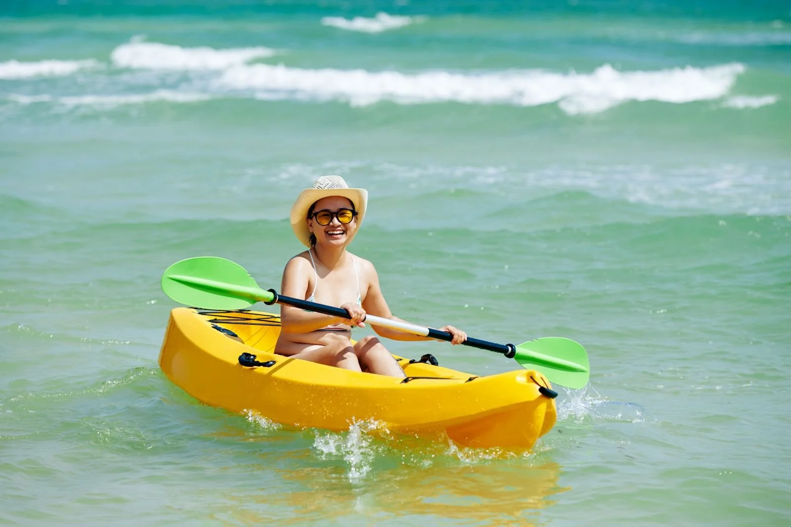 Women kayaking in Garrapatero beach Galapagos