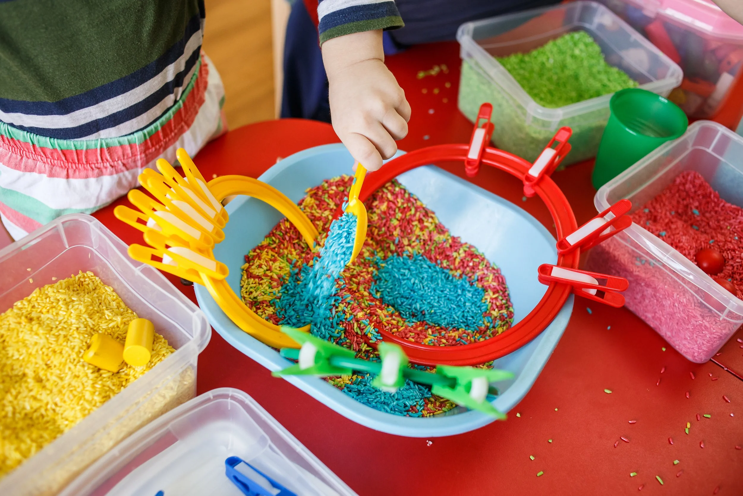 children playing in sensory rice bin