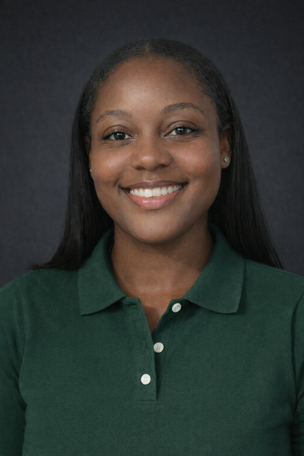 A woman with dark hair wearing a dark green polo 