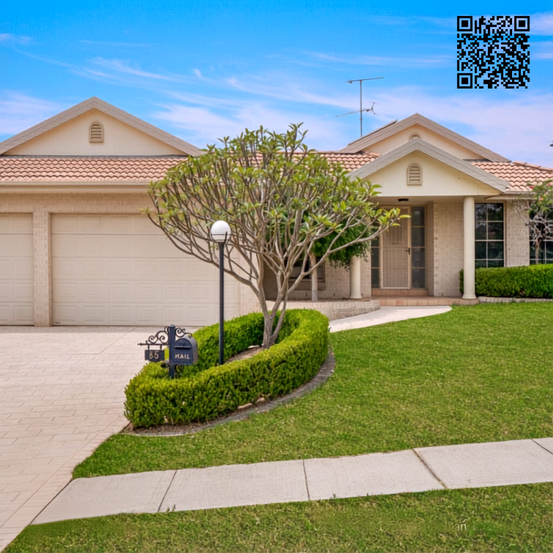 Front view of a suburban house with a two-car garage, manicured lawn, a tree, and a mailbox with the number 135.