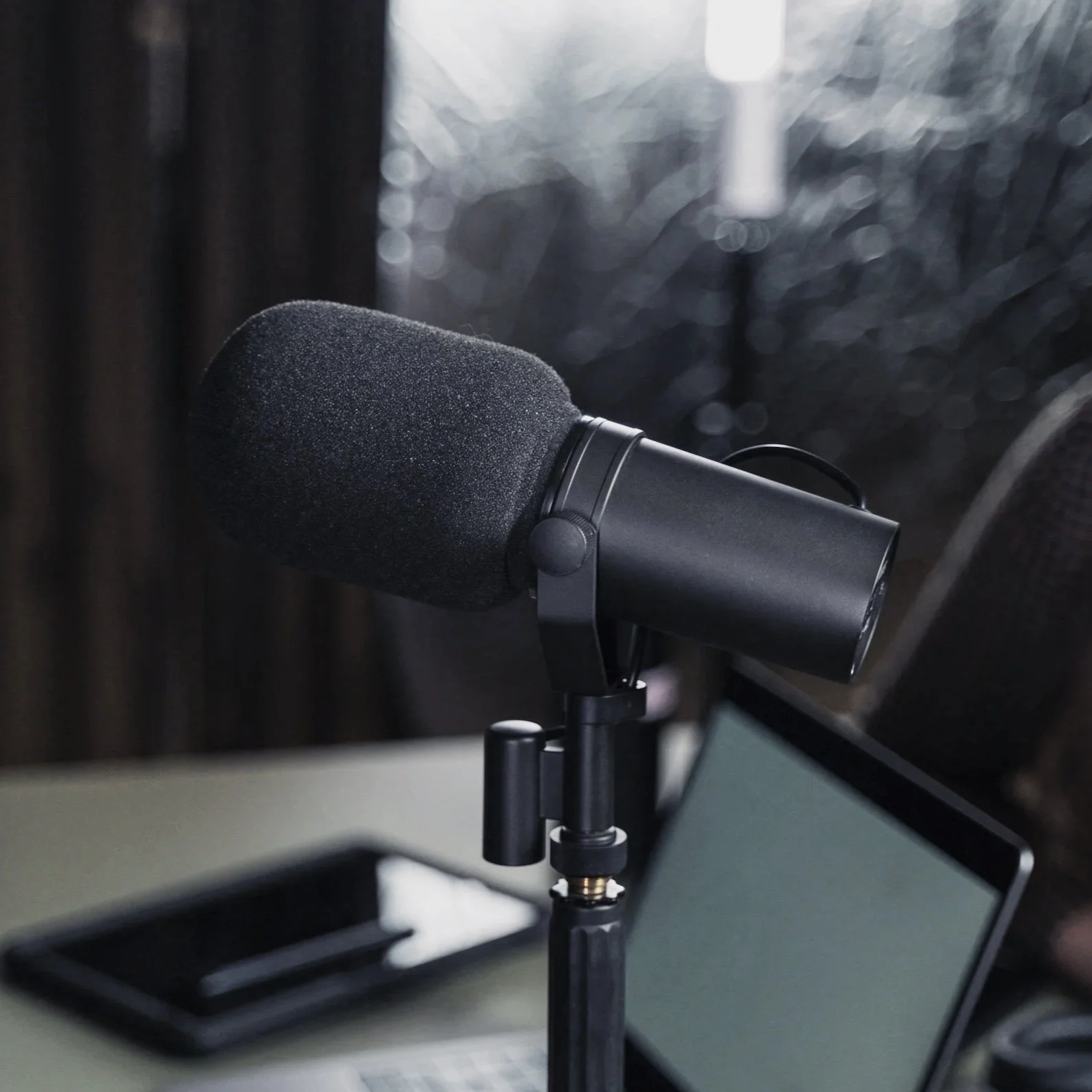 podcast microphone and laptop computer