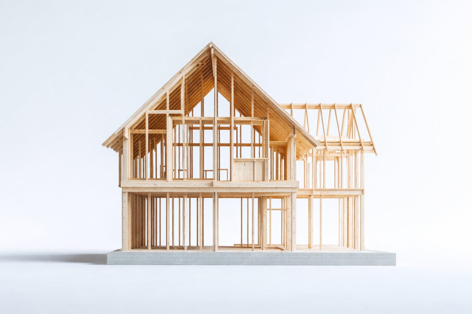 Wooden house frame under construction with exposed beams and roof structure.