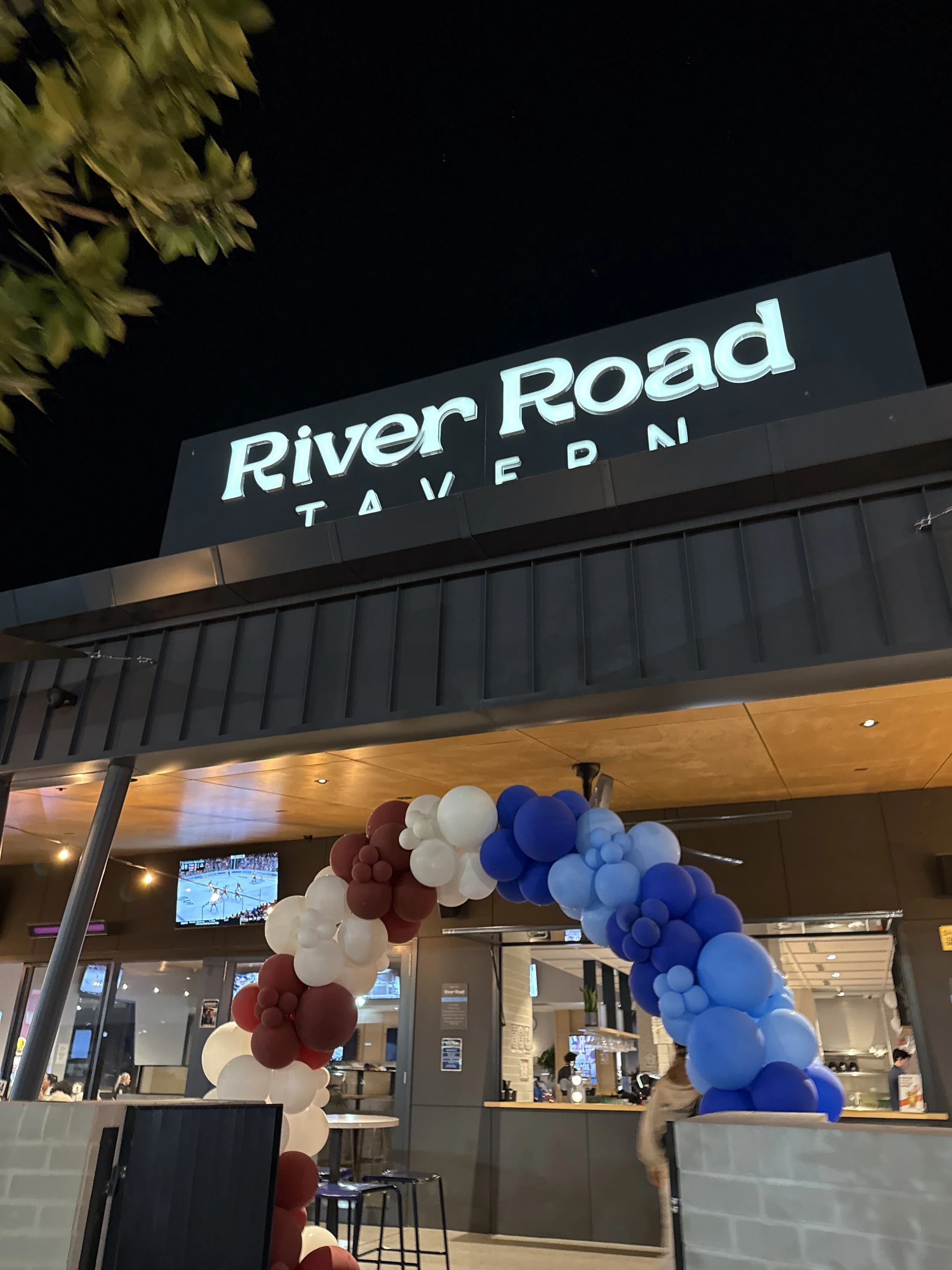 NRL State of Origin ballon arch with marroon, whit, navy and light blue balloons.
