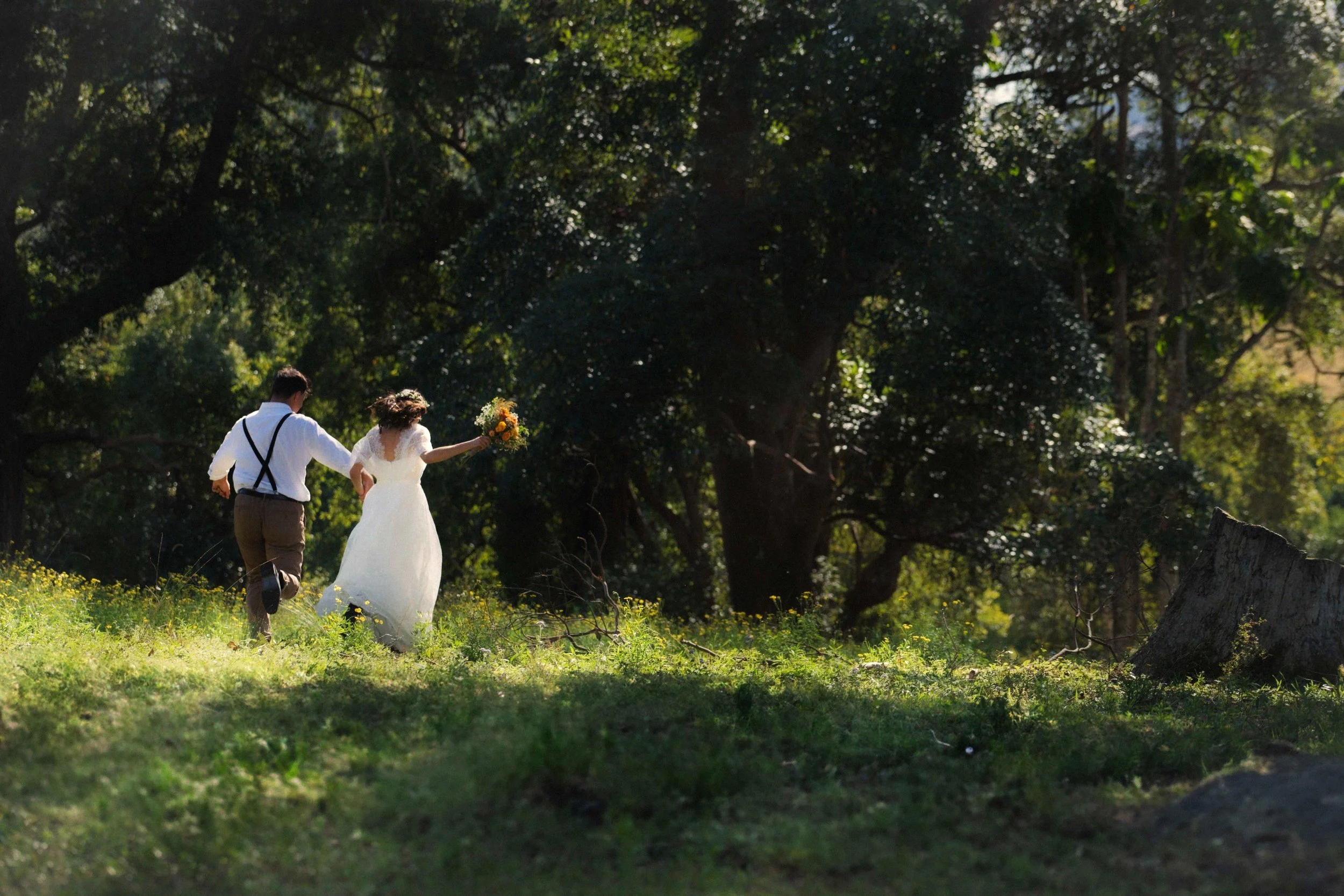 bride and groom candid running prairie