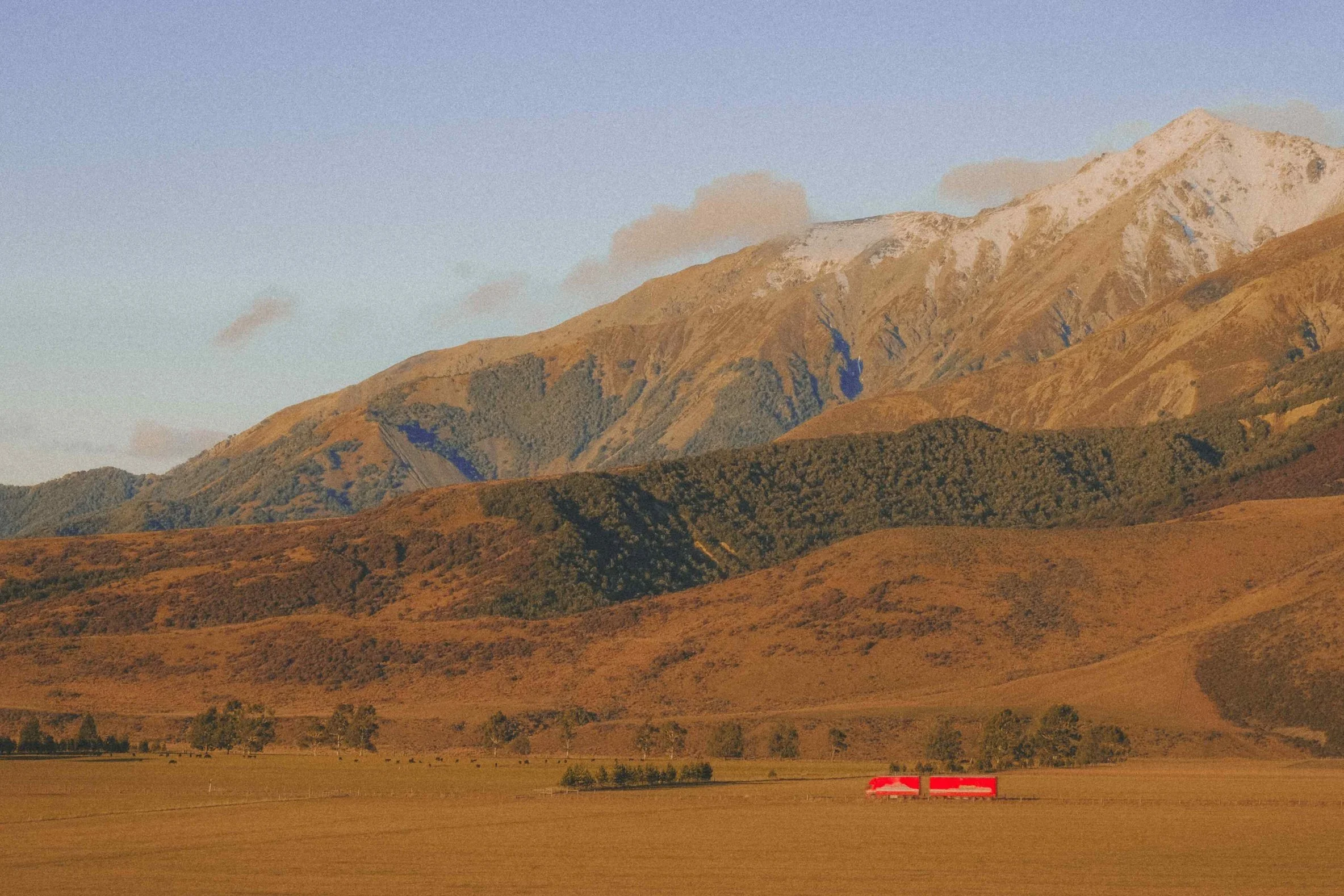 New Zealand mountains red truck golden hour