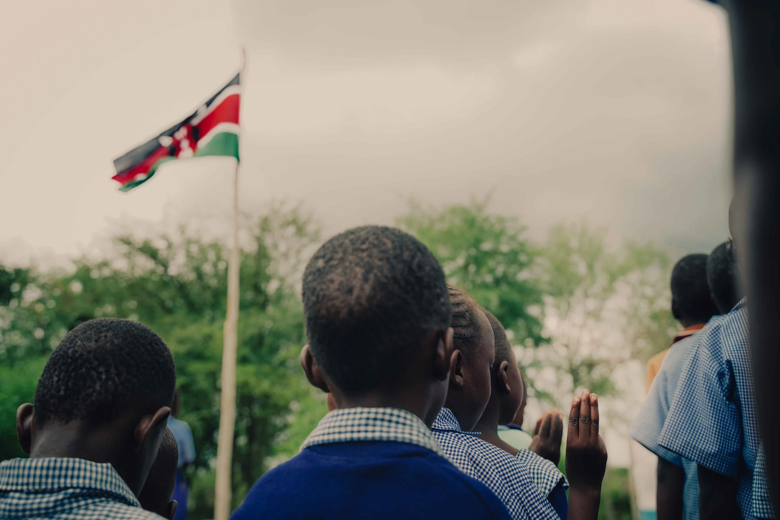 kids paying tribute to Kenya flag